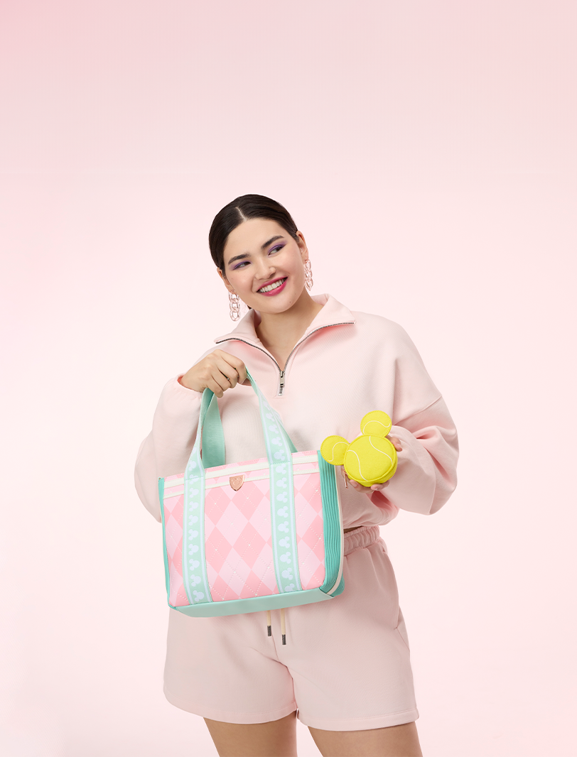 Pink background featuring model with Disney Mickey Tennis tote bag