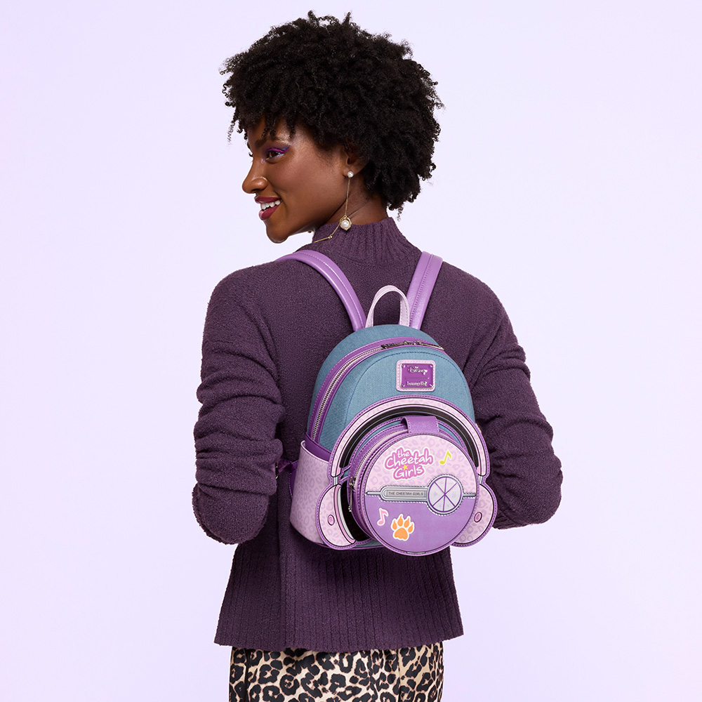 purple background with model wearing Cheetah Girls backpack on her back