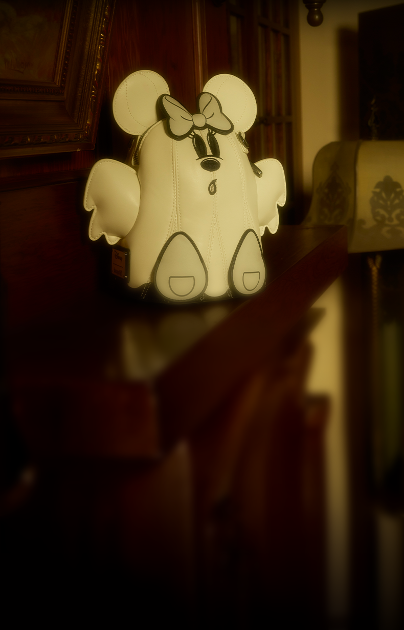 Woman in a white lace dress holding a Disney Mickey Mouse Ghost bag in a vintage, warmly lit interior