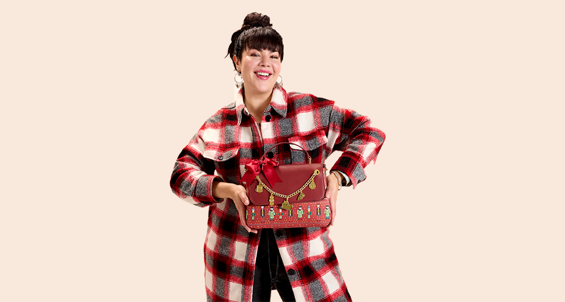 Solid colored Tan background with model showcasing Loungefly Home Alone accessories