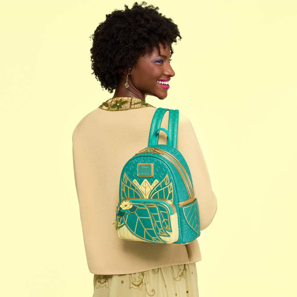 yellow background with model holding Princess and the Frog Loungefly backpack