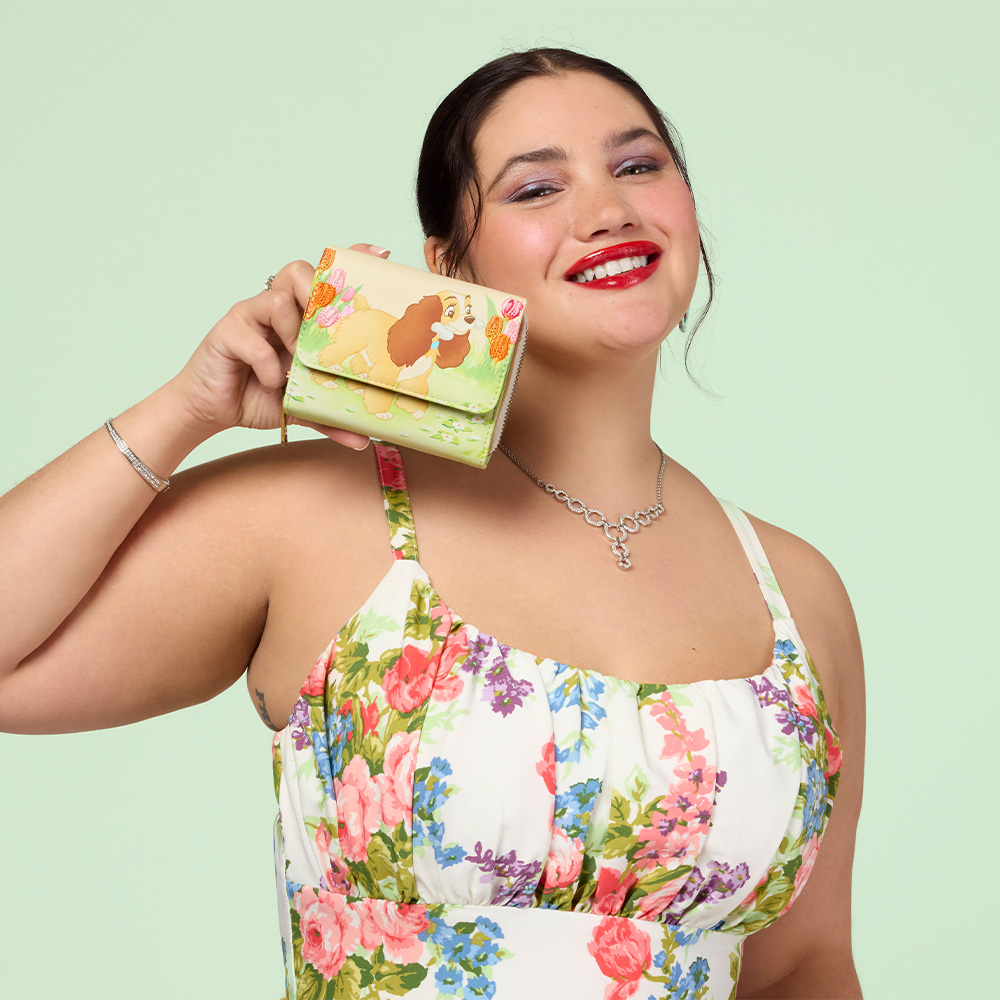 Green background with model showcasing Loungefly Disney Lady & the Tramp Wallet