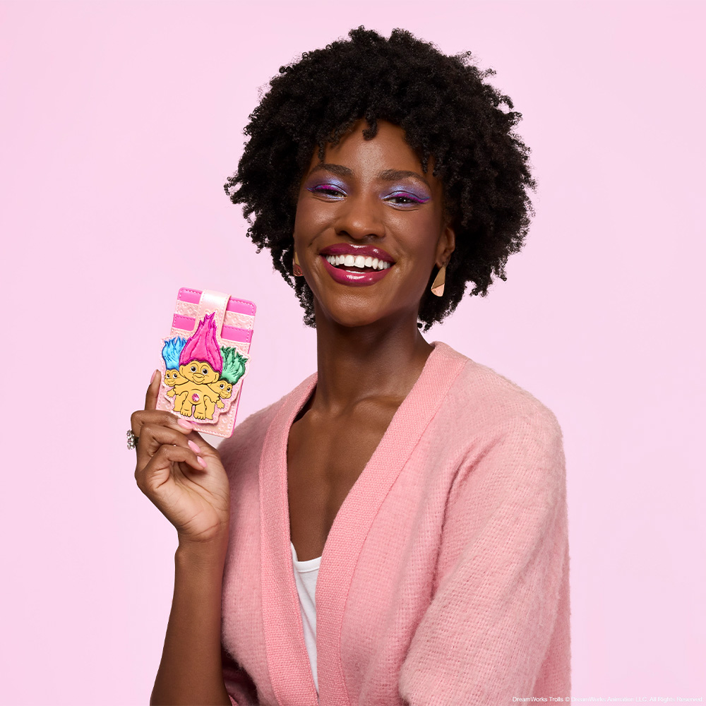 Pink background with model showcasing Loungefly Good Luck Trolls wallet