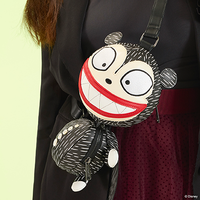 Green background featuring on model shot of Loungefly New York Comic Con Scary Teddy Crossbody Bag