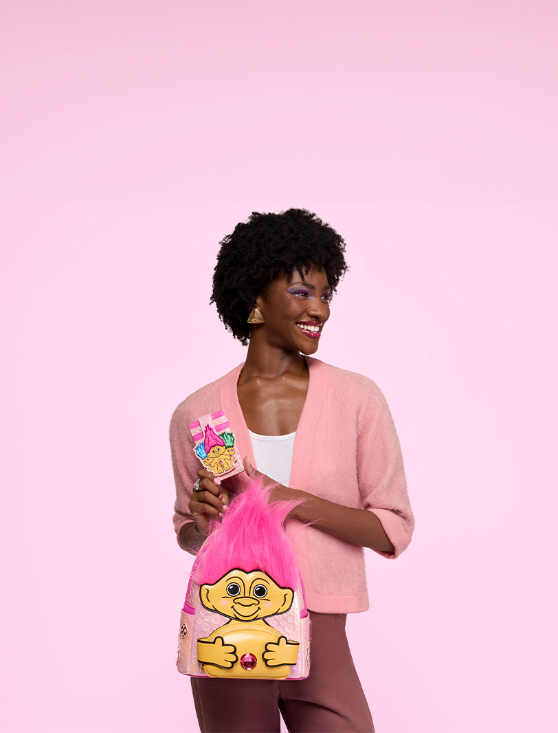 Pink background with model showcasing Loungefly Good Luck Trolls exclusive collection