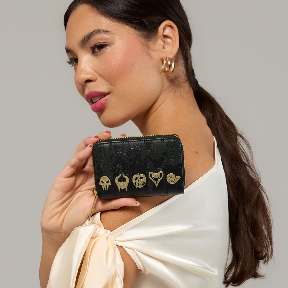 Gray background with model holding Loungefly Disney Villains wallet