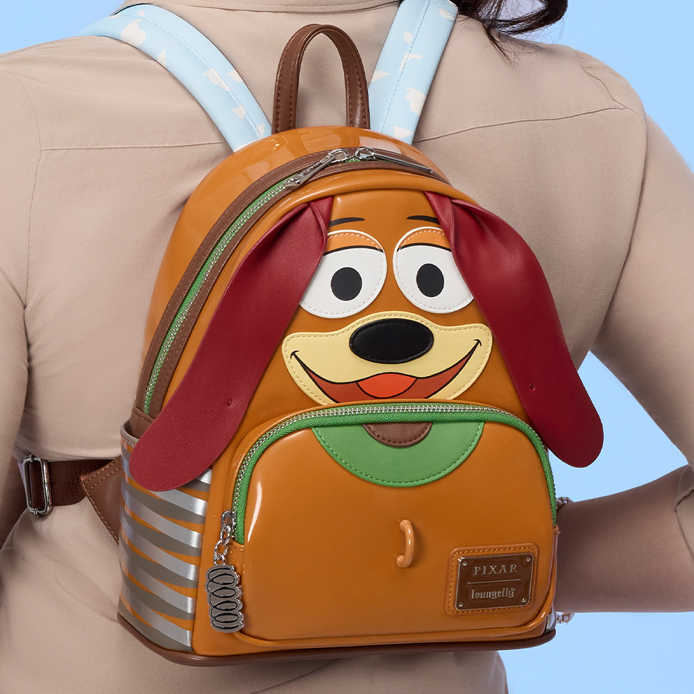 Blue background with model wearing Loungefly Disney Pixar Toy Story Slinky mini backpack