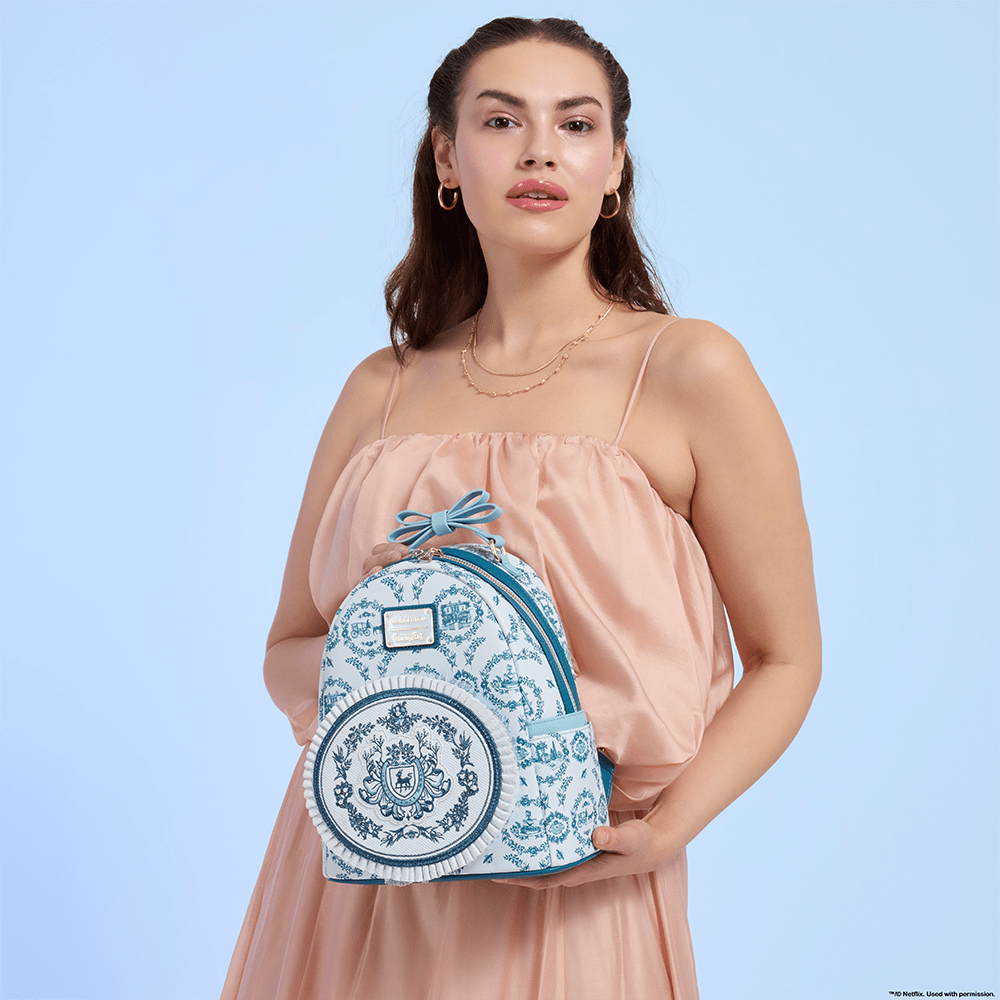 Blue background with model showcasing Loungefly Netflix Bridgerton mini backpack