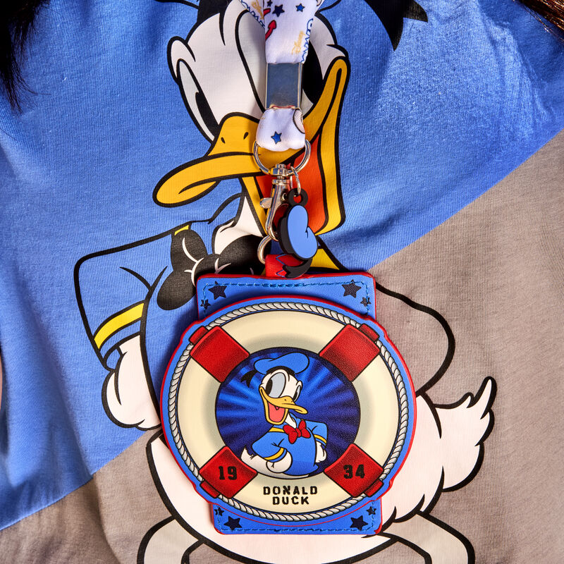 Loungefly Donald Duck 90th Anniversary Lanyard with Card Holder resting against the Loungefly Donald Duck 90th Anniversary Unisex Tee 