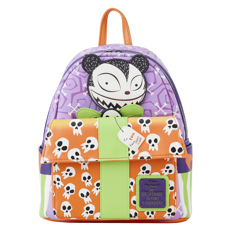 Image of our Nightmare Before Christmas Scary Teddy Present Mini Backpack featuring Scary Teddy popping up behind an orange present front pocket with a purple wrapping paper behind him. 