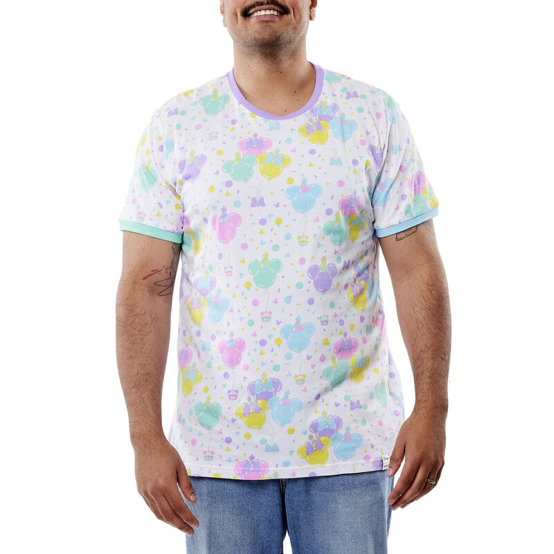 Man wearing the white Mickey and Friends Birthday Tee with pastel motifs of balloons 