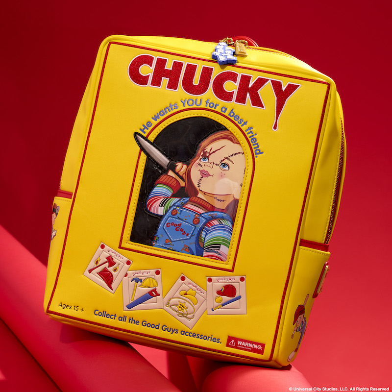 Yellow, rectangular Loungefly mini backpack that looks like a Chucky box, featuring Chucky holding a knife. It sits against a red background. 