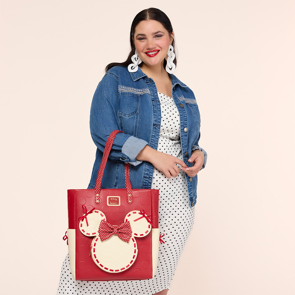 Tan background with model showcasing Loungefly Disney Minnie Rocks the Dots Tote