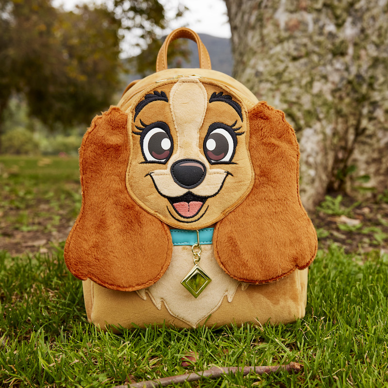 Image of our exclusive Lady and the Tramp Plush Mini Backpack sitting outside in the grass