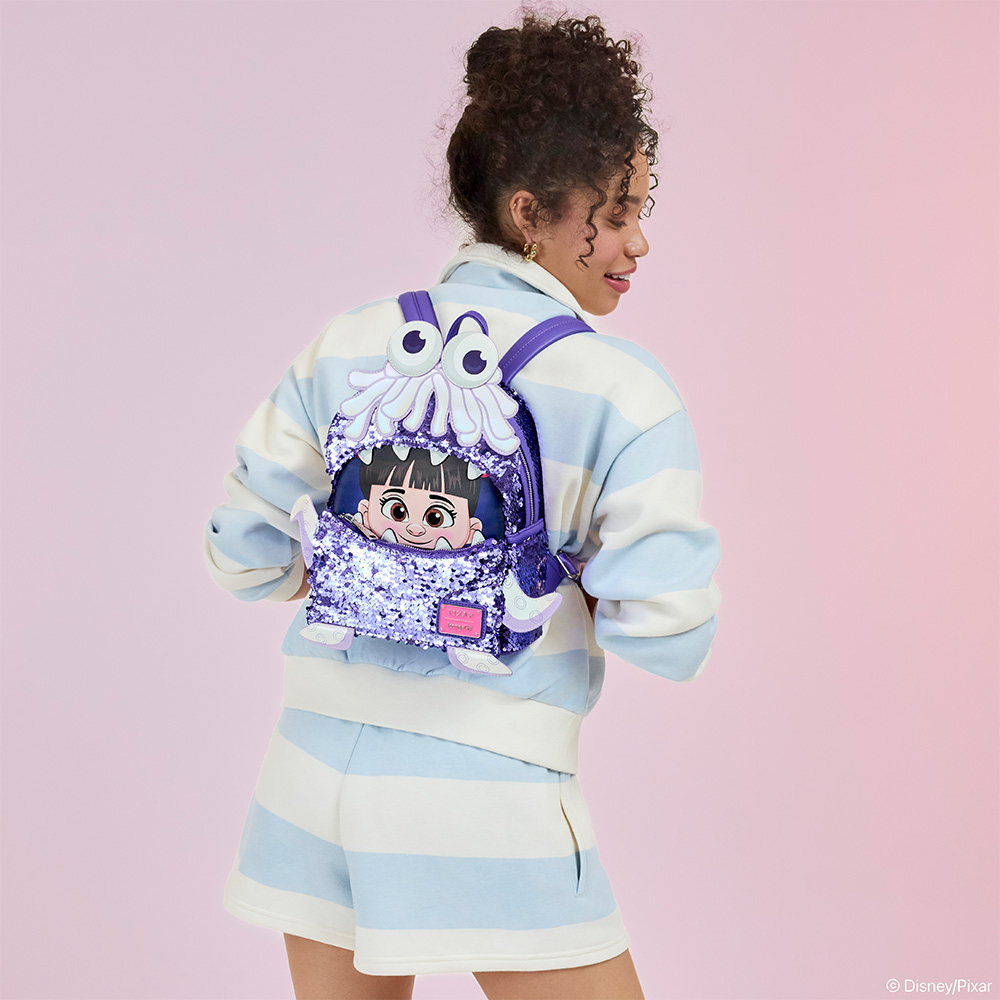 Light Purple background with model showcasing Monsters, Inc. Exclusive Boo Costume Sequin Mini Backpack