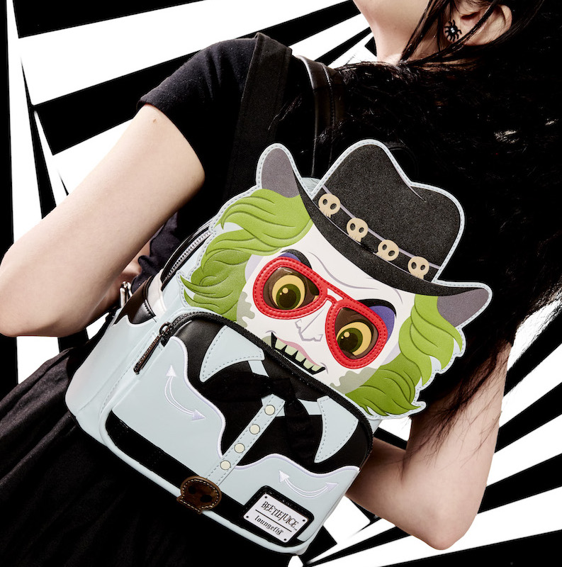 Woman facing away from camera wearing all black, wearing the Beetlejuice Western Cosplay Mini Backpack, featuring Beetlejuice in his western ensemble from his commercial. The woman stands against a black and white background.