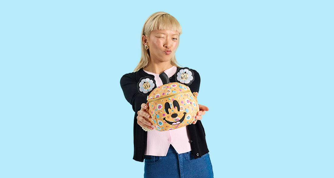 Light Blue background with model showcasing Loungefly Disney Mickey & Friends Halloween collection