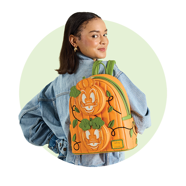 Circle-cropped photo with Green background and model showcasing Loungefly Disney Donald and Daisy Jack-o-Lantern Mini Backpack