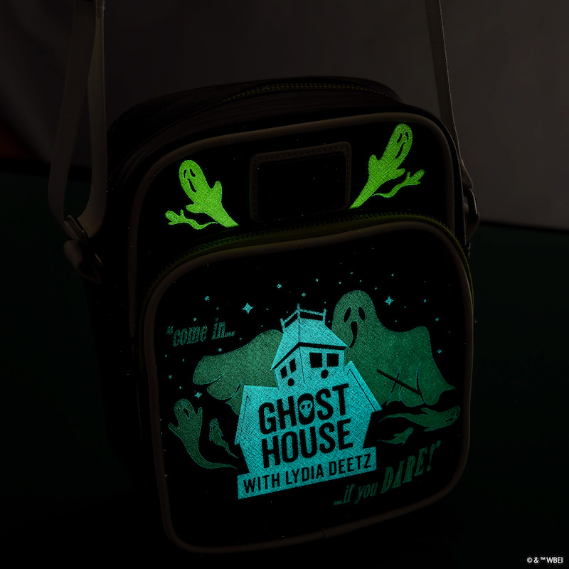 Loungefly Beetlejuice Beetlejuice Ghost House Glow Crossbody bag in the dark to show the glow in the dark features - the ghosts and house glow