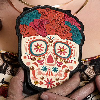 Model hands holding Loungefly Dia de los Muertos Card Holder