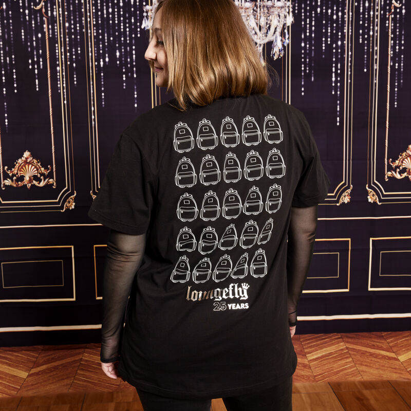 Shot of woman wearing the Loungefly 25th anniversary unisex tee, showing the back of the shirt with 25 mini backpacks on the back.