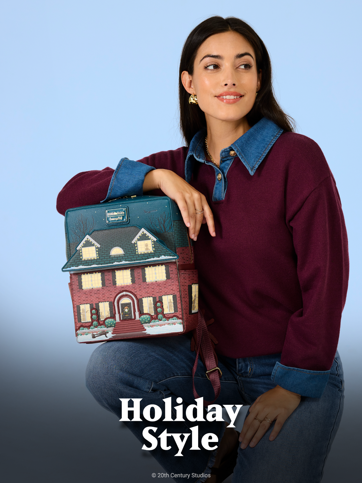 Blue background with model showcasing Loungefly Home Alone mini backpack