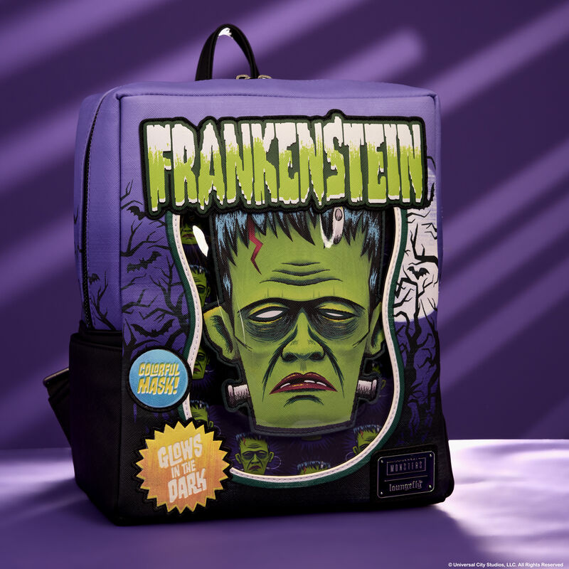 Loungefly mini backpack featuring a design that looks like a box with a Frankenstein mask inside. It sits against a purple background.