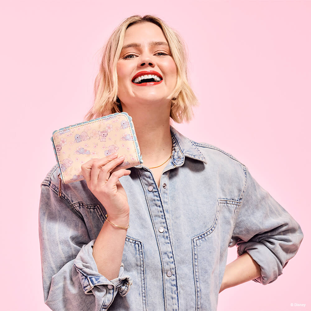 Pink background with model holding Stitch & Angel Cherry Blossom All-Over Print Zip Around Wallet