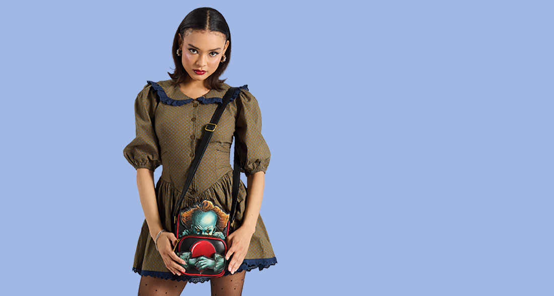 Model showcasing Loungefly Warner Brothers IT Pennywise Crossbuddies Bag