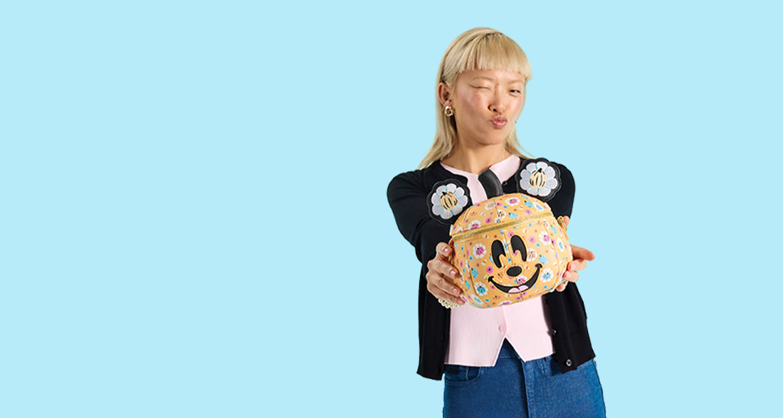Light Blue background with model showcasing Loungefly Disney Mickey & Friends Halloween collection