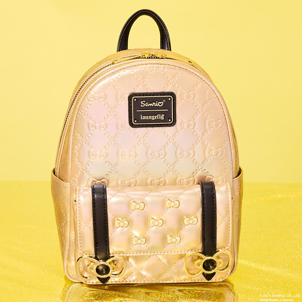 Yellow product background with reflective surface featuring Sanrio Hello Kitty 50th Anniversary Metallic Gold Mini Backpack