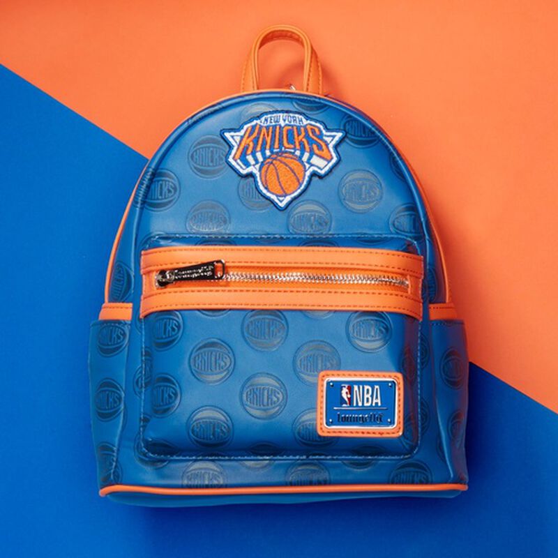Image of our Knicks Logo Mini Backpack against a blue and orange background