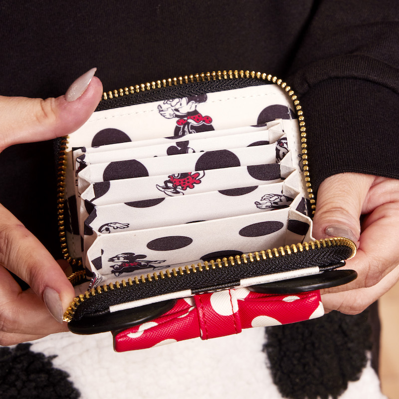 Image of hands holding the Minnie Rocks the Dots Accordion Wallet with the wallet open