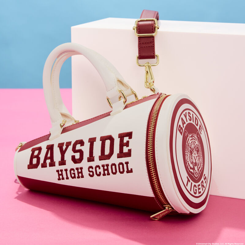 Figural Loungefly crossbody bag in the shape of a Bayside High School megaphone from Saved by the Bell. It sits against a white cube against a pink and blue background. 