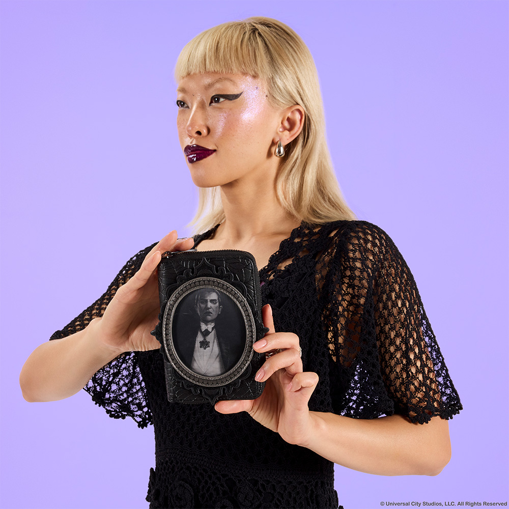 Purple background with model showcasing Loungefly Universal Monsters exclusive wallet