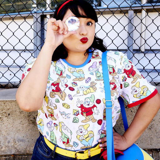 Woman wearing the Snow White Ringer Tee and holding a large gem up to her eye