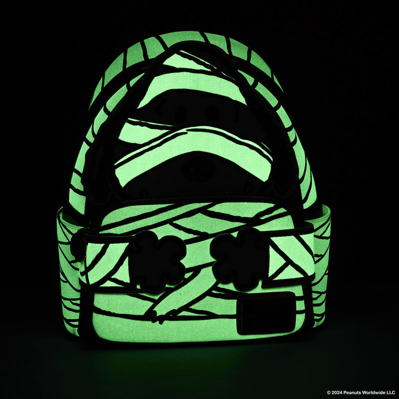 Loungefly mini backpack featuring Snoopy dressed as a mummy. The bag is in the darkness to show the glow in the dark mummy wrappings.