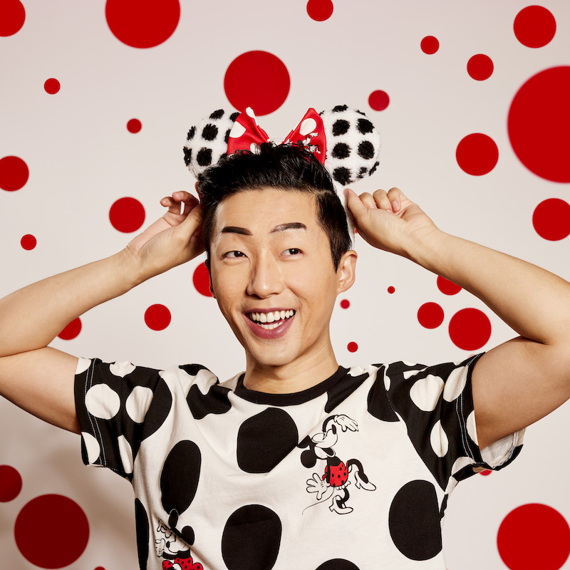 Image of man wearing the Minnie Rocks the Dots Classic Sherpa Ear Headband with the bow in the center 