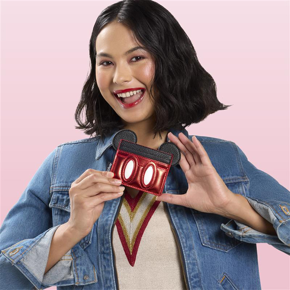 Pink background with model showcasing Loungefly Disney Mickey Mouse wallet