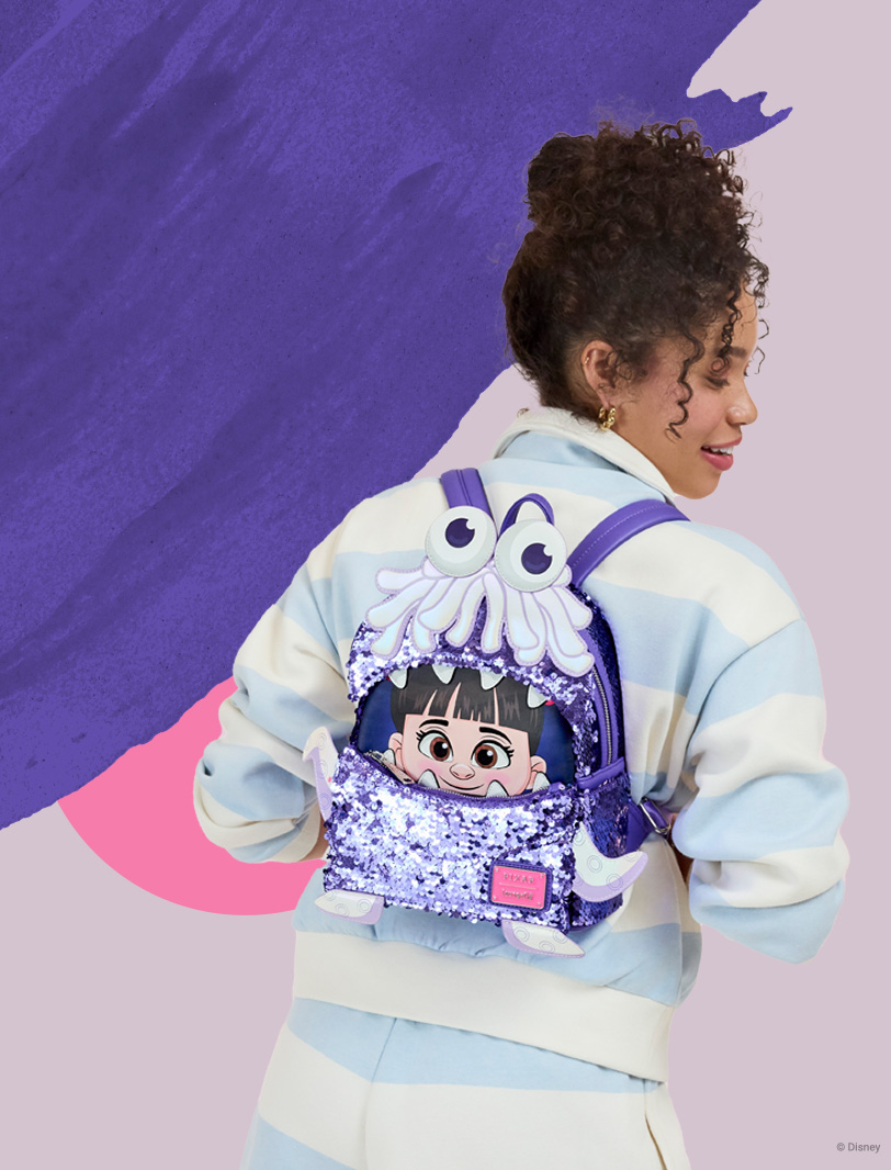 Purple Pink background with model featuring Loungefly May Pixar Monsters Inc Boo exclusive