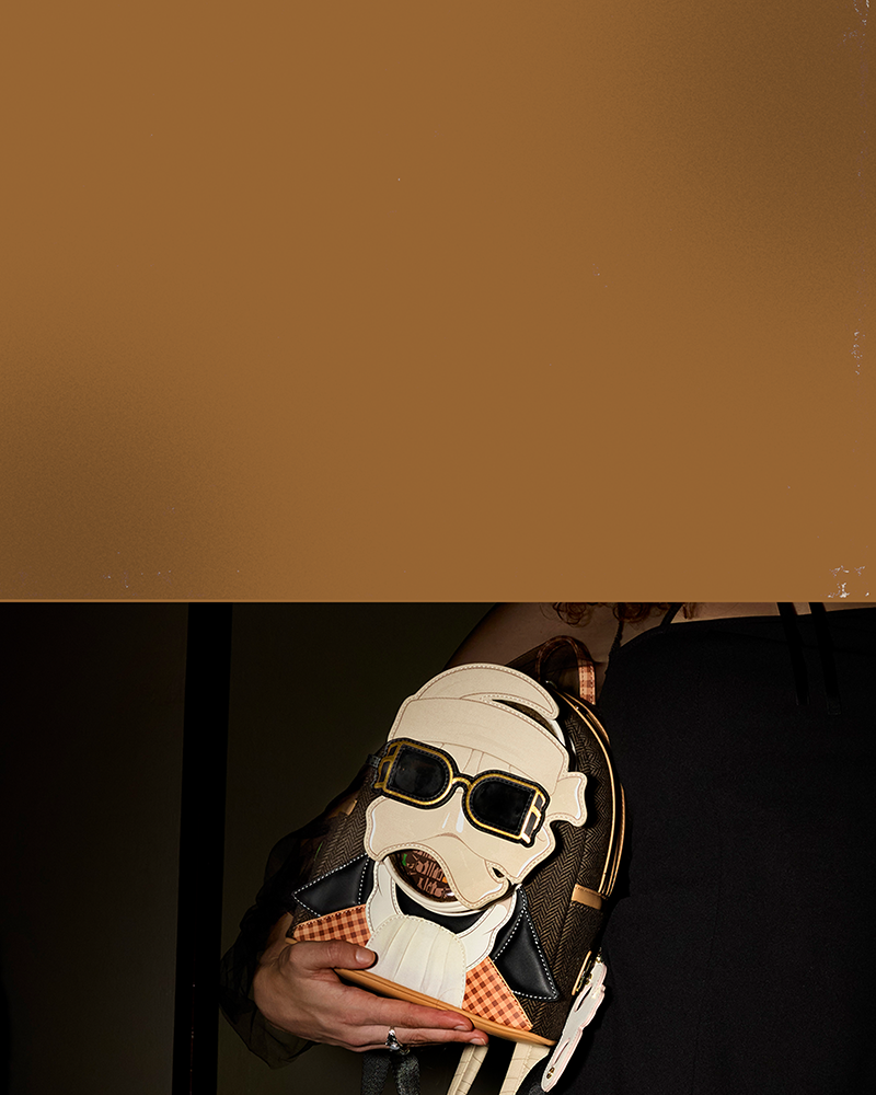 Brown color gradient with lifestyle of models showcasing Loungefly Universal Monsters Invisible Man mini backpack