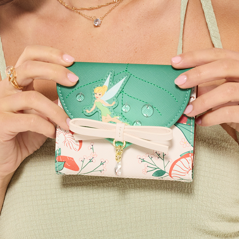 Model with Green dress showcasing Loungefly Disney Fairies wallet