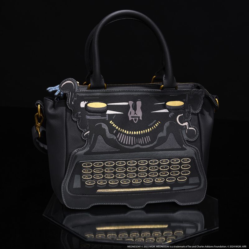 Loungefly crossbody bag that looks like Wednesday Addams' typewriter. It sits against a black background. 