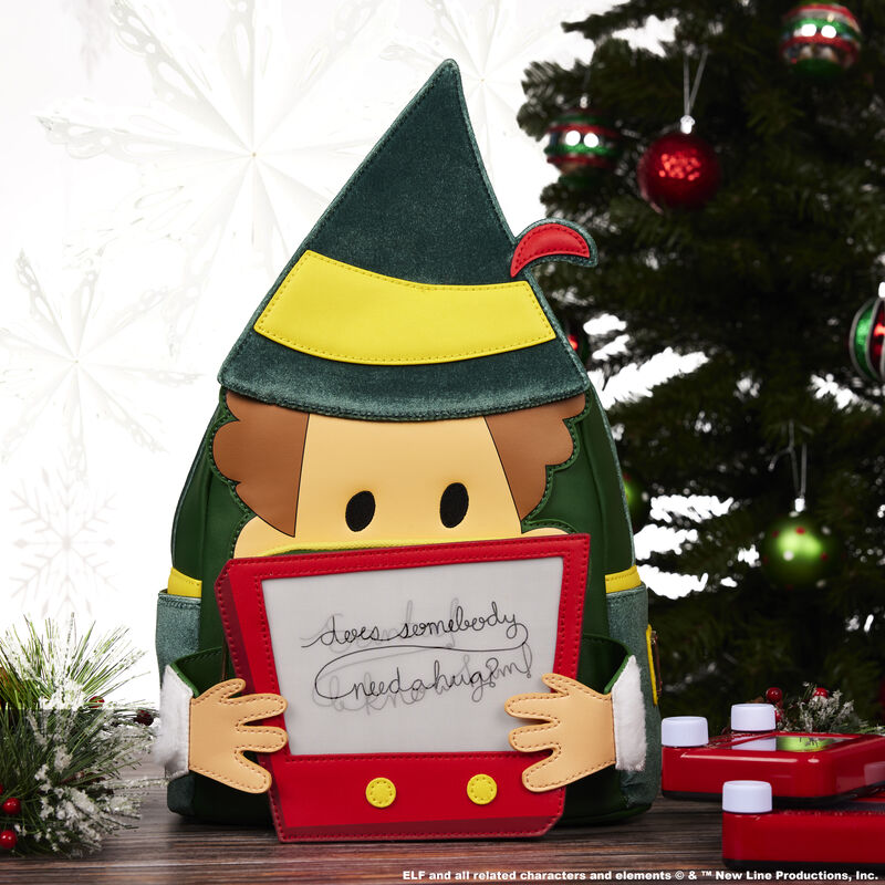Image of our Elf 20th Anniversary Cosplay Lenticular Mini Backpack sitting beside a Christmas tree 
