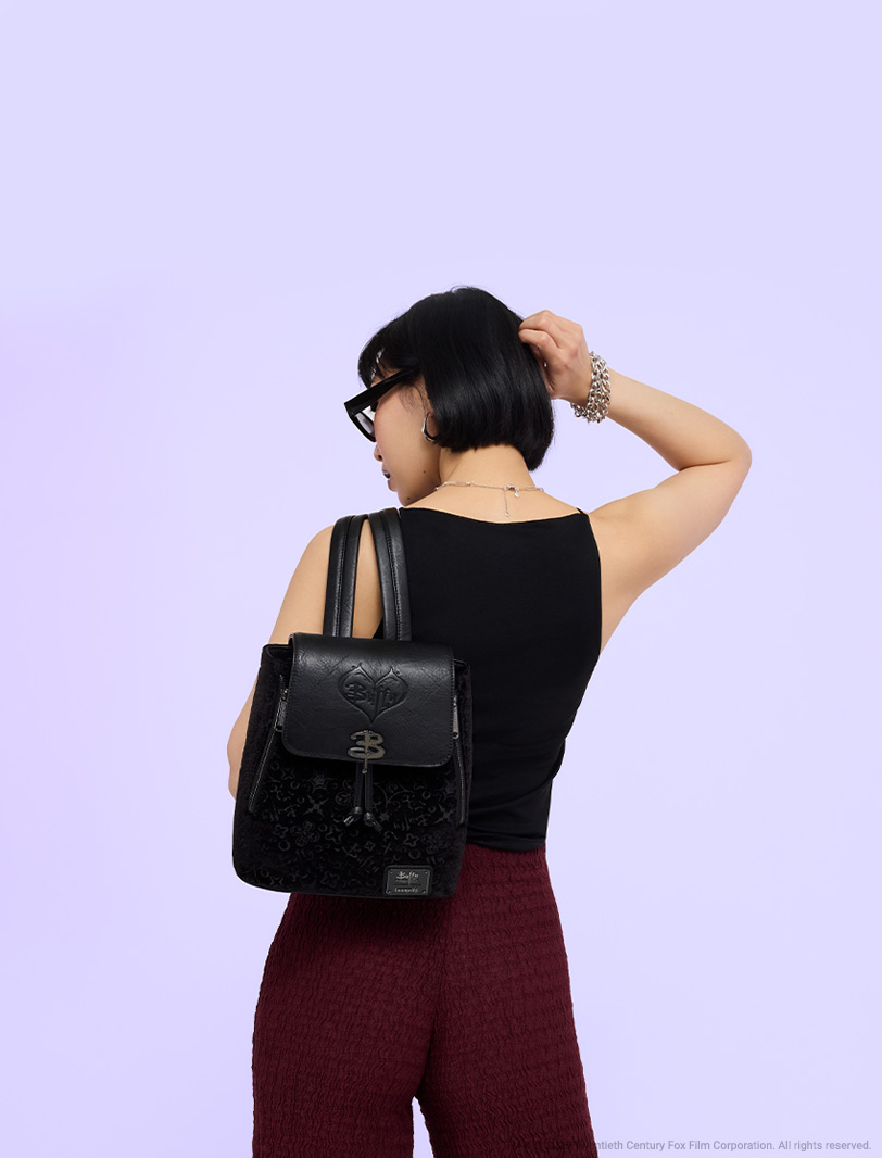 Purple background with model showcasing Loungefly July Buffy the Vampire Slayer mini backpack