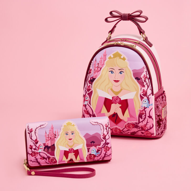Image of the Loungefly Sleeping Beauty Princess Aurora Roses Mini Backpack & wallet sitting against a pink background. 