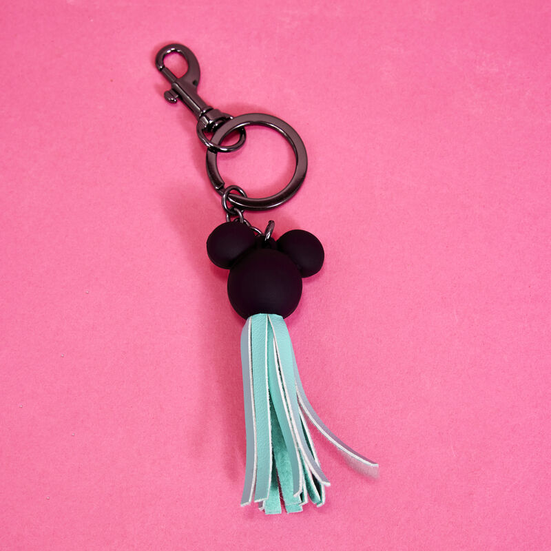 Image of our Mickey Mouse Classic Tassel Bag Charm against a pink background 