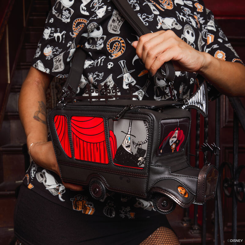 Person wearing a Loungefly Disney Tim Burton's Nightmare Before Christmas Unisex Tee and holding the figural Mayor-Mobile light-up crossbody, featuring light-up headlights and lenticular features