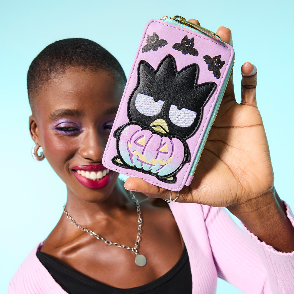 Blue background with model showcasing Loungefly Sanrio Badtz-Matu Halloween wallet