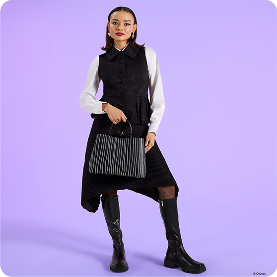 Purple background with model showcasing Loungefly August Nightmare Before Christmas collection